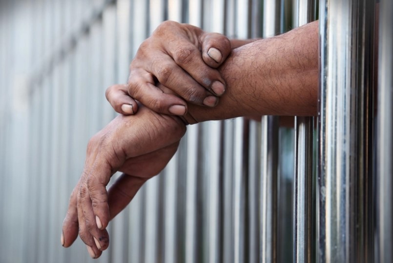 Prisoner behind bars